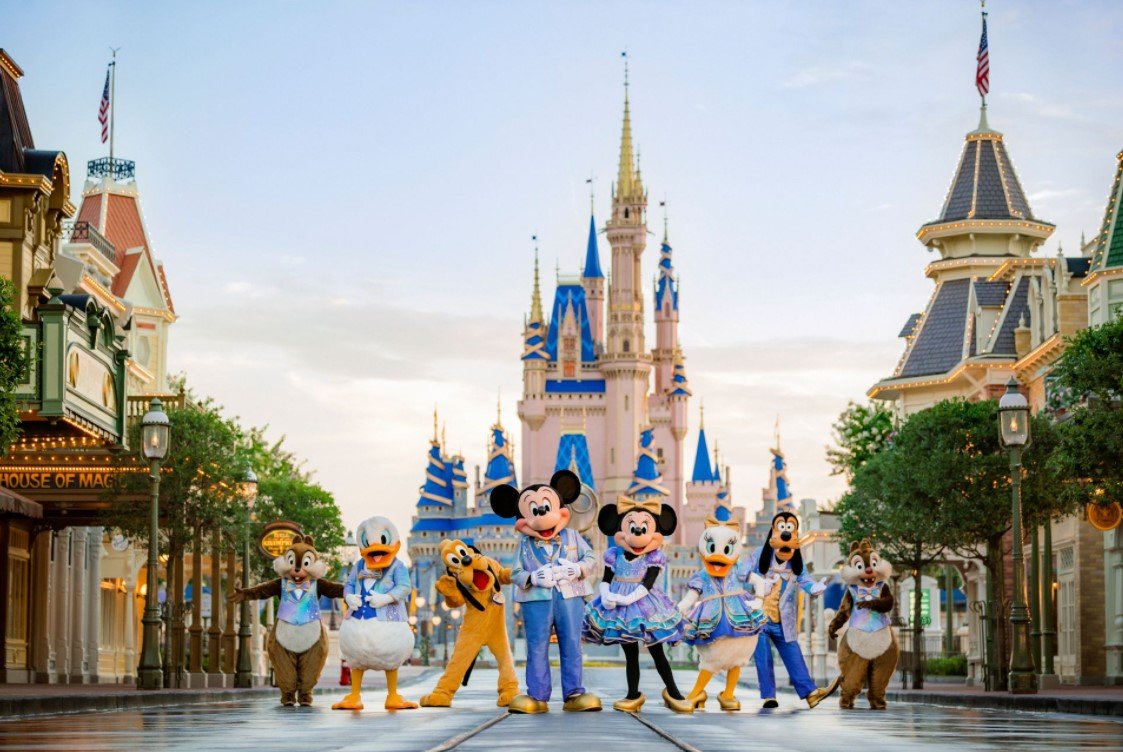 magic kingdom castle with characters in front